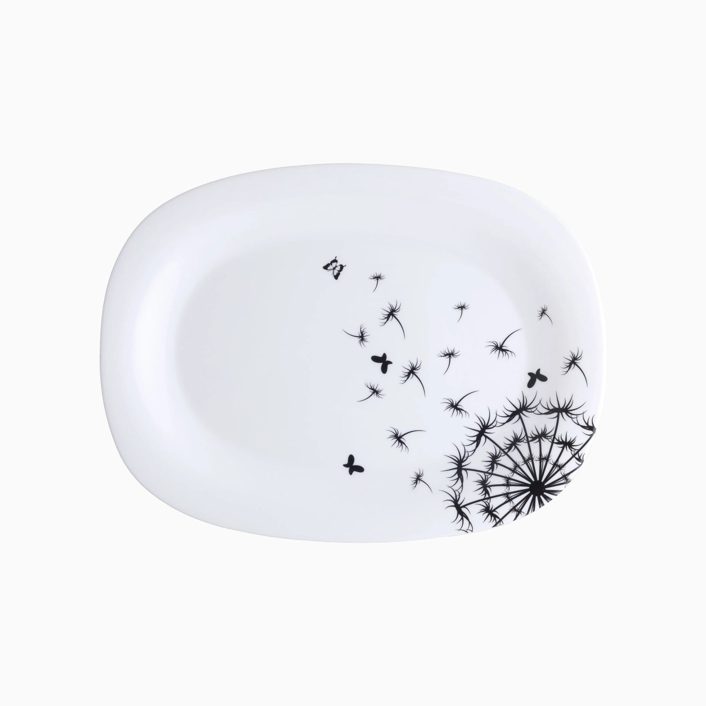White ceramic plate with black dandelion design on a white background