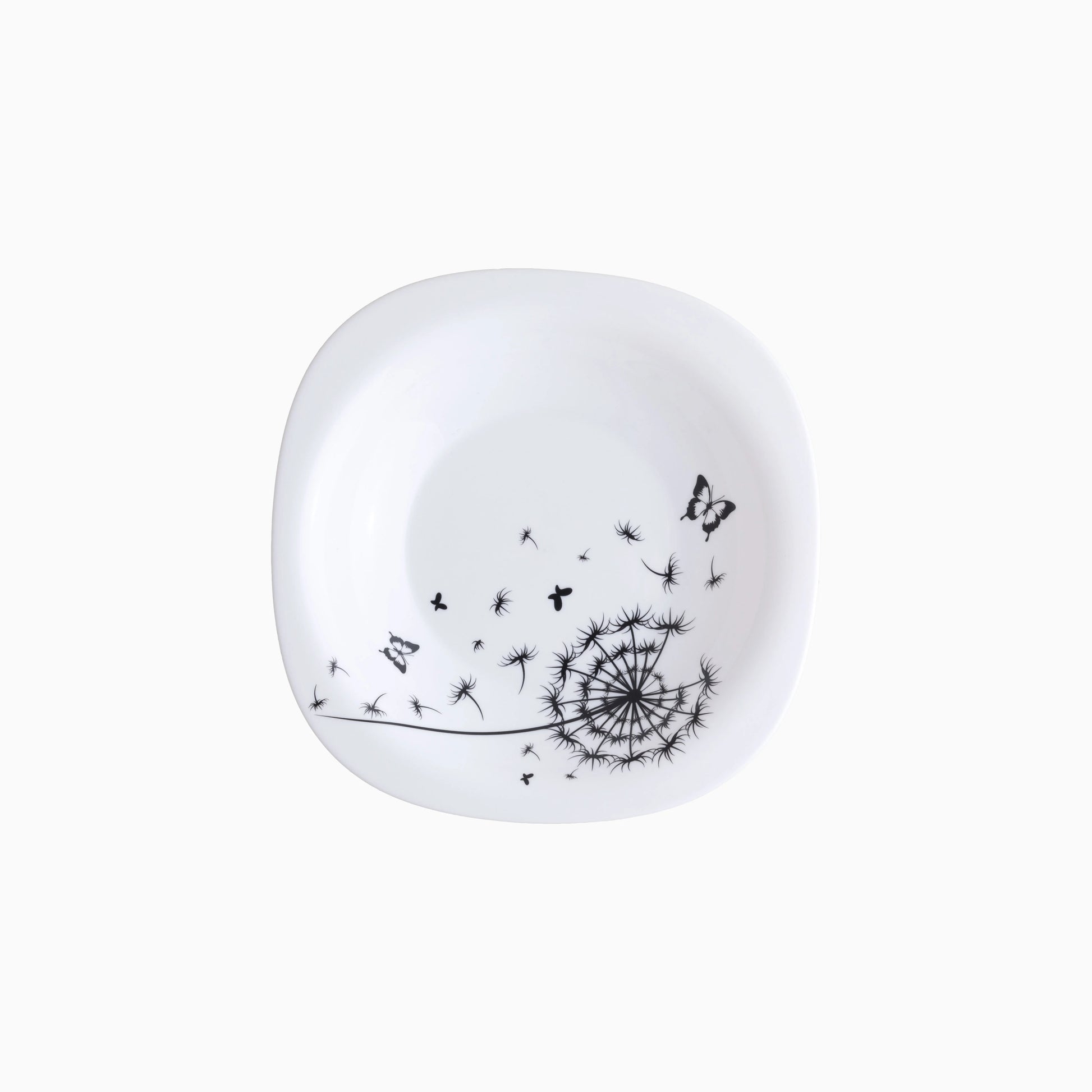 White soup plate with black dandelion and butterfly design on a white background