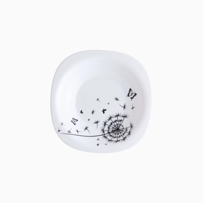 White soup plate with black dandelion and butterfly design on a white background