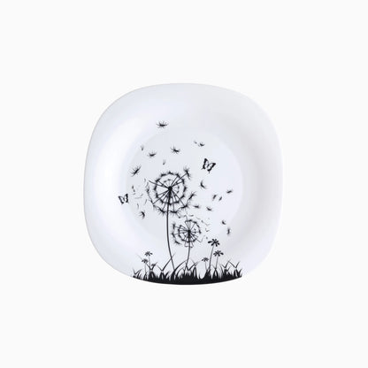 White plate with black dandelion and butterfly design on a white background