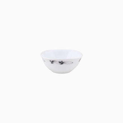 A set of white dinnerware with a floral pattern, including plates and bowls.