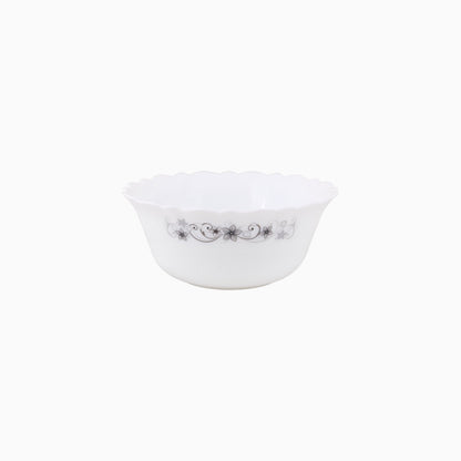 A set of white dinnerware with a floral pattern, including plates, bowls, and mugs.