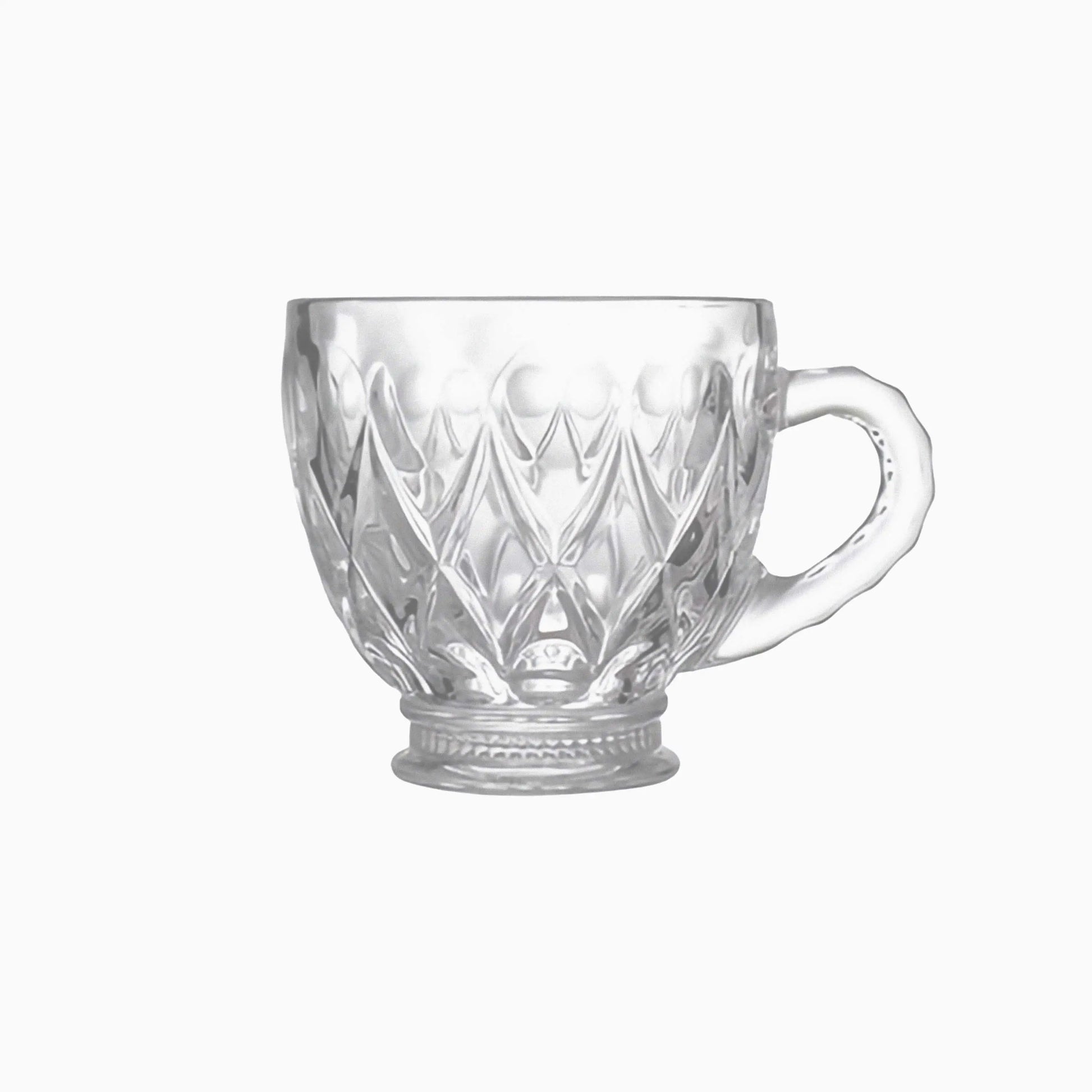 Clear glass mug with diamond cut pattern on a white background
