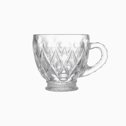 Clear glass mug with diamond cut pattern on a white background