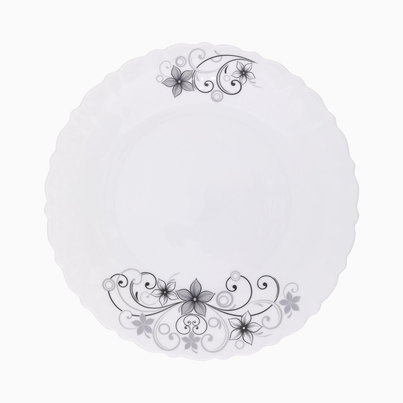 A set of white dinnerware with a floral pattern, including plates, bowls, and mugs.