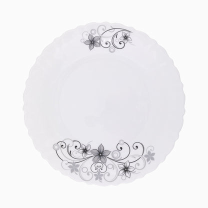 A set of white dinnerware with a floral pattern, including plates, bowls, and mugs.