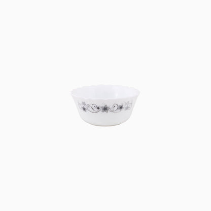 A set of white dinnerware with a floral pattern, including plates, bowls, and mugs.