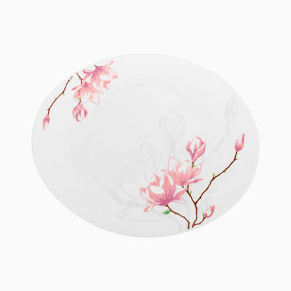Oval white plate with pink floral design on a white background