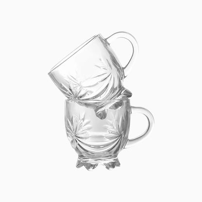 Two clear glass mugs stacked on a white background