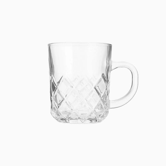 Clear glass mug with diamond cut pattern on a white background