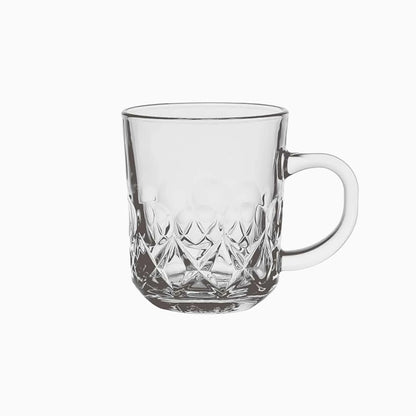 Clear glass mug with diamond cut pattern on a white background