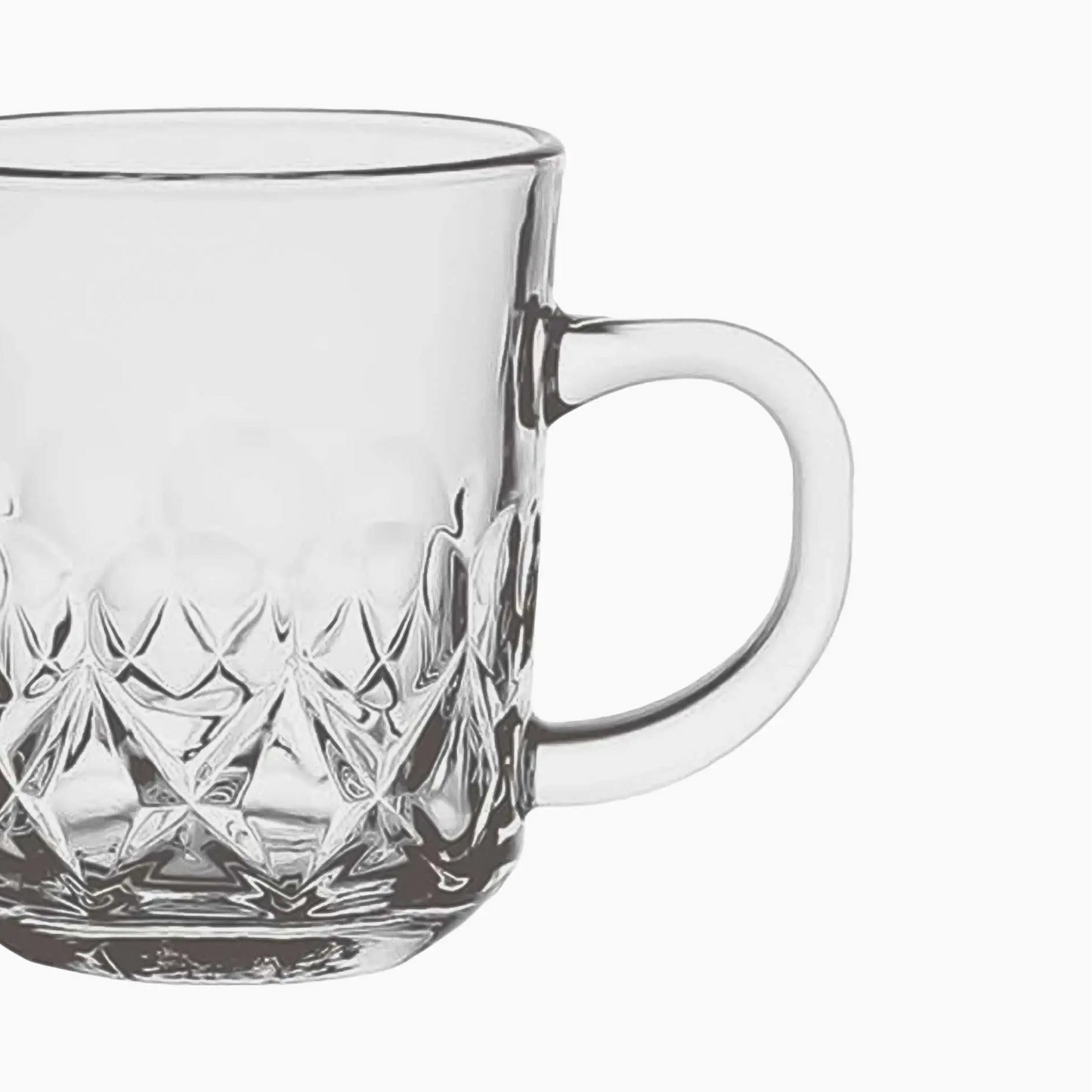 Clear glass mug with diamond cut pattern on a white background