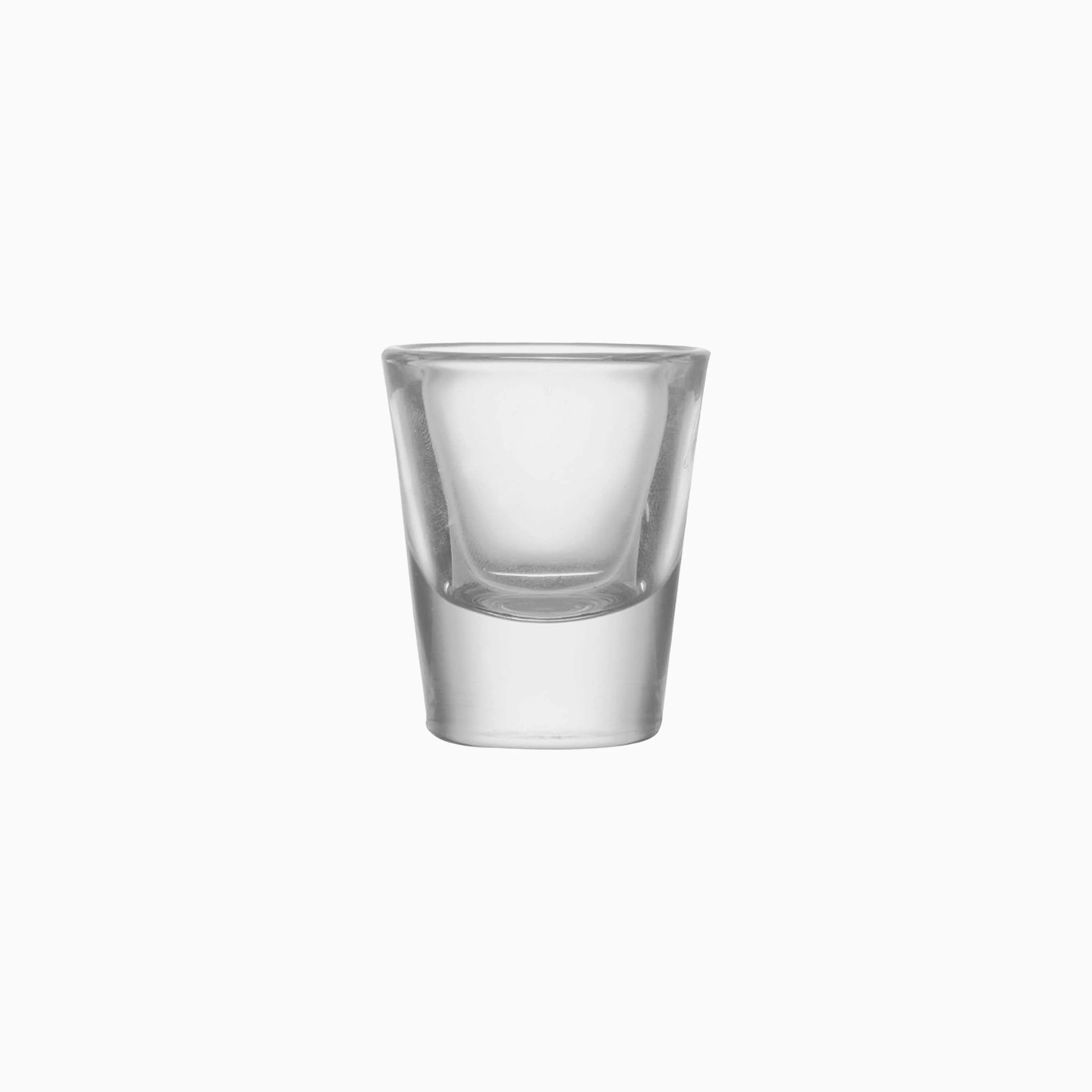 Clear glass shot glass on a white background