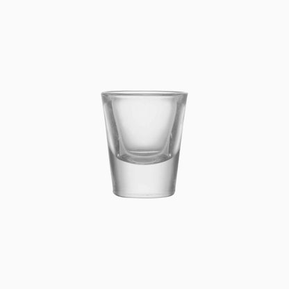 Clear glass shot glass on a white background