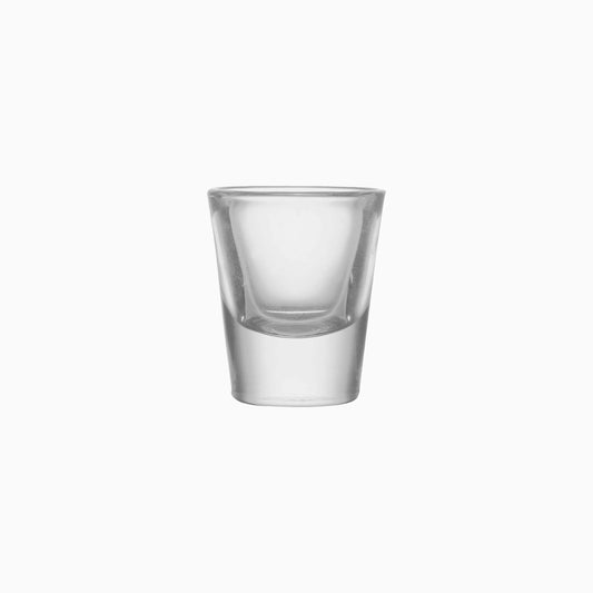 Clear glass shot glass on a white background