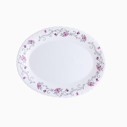 A set of white opal dinnerware with a floral pattern around the rim, including plates and bowls.