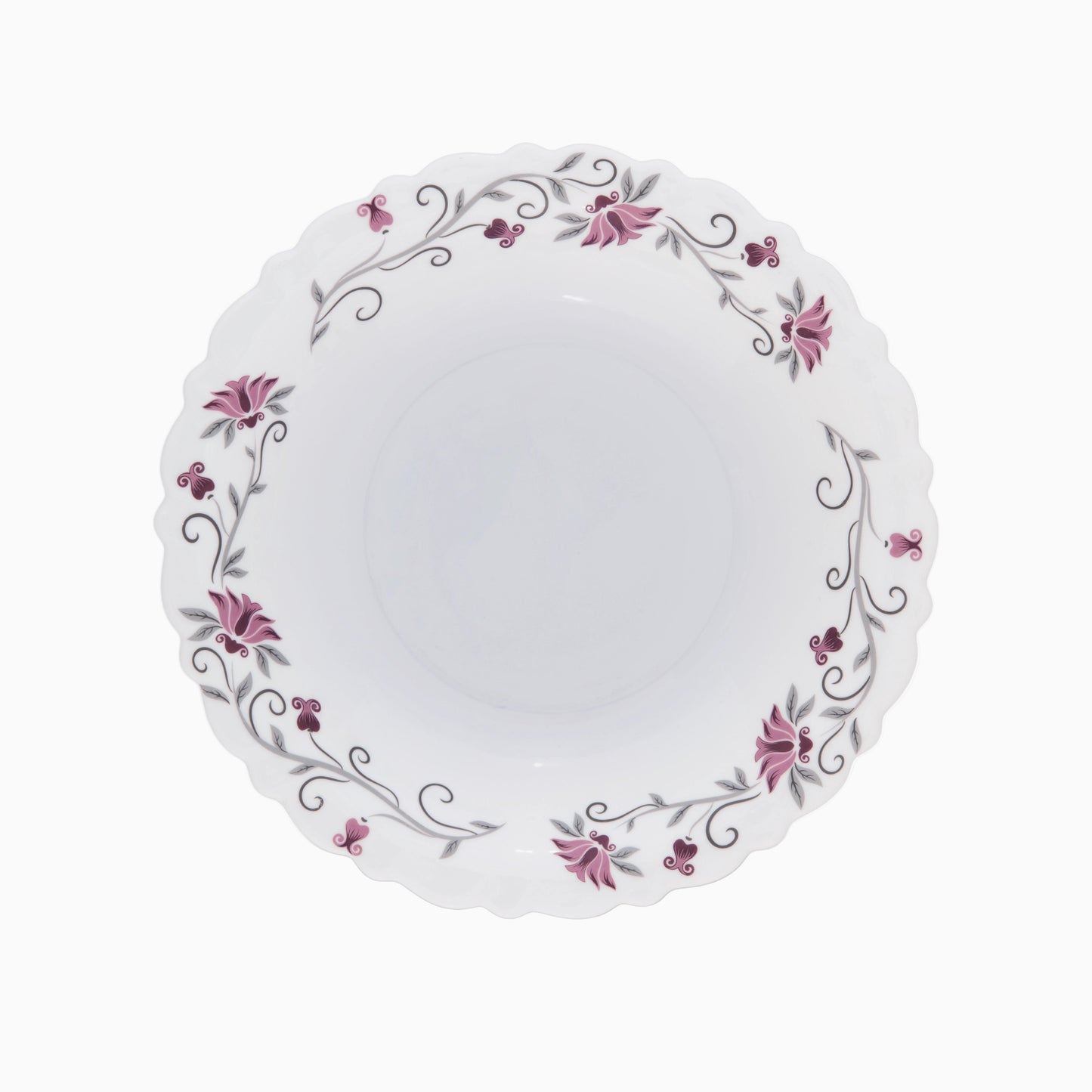 A set of white opal dinnerware with a floral pattern around the rim, including plates and bowls.