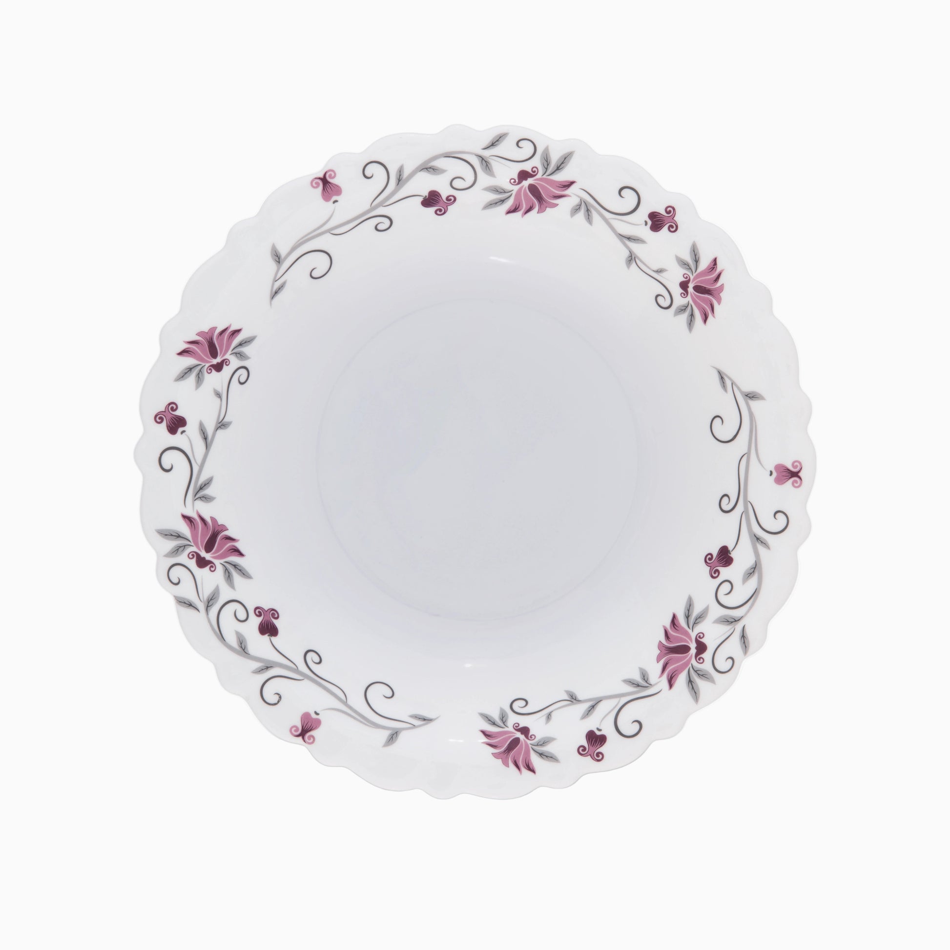 A set of white opal dinnerware with a floral pattern around the rim, including plates and bowls.