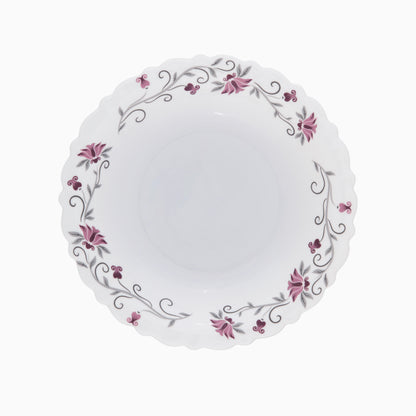 A set of white opal dinnerware with a floral pattern around the rim, including plates and bowls.
