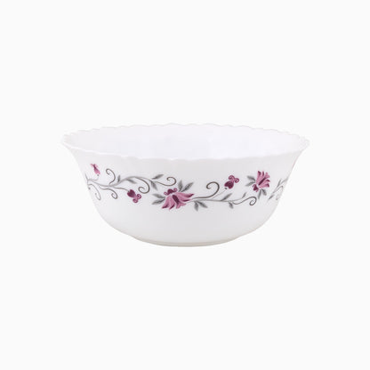 A set of white opal dinnerware with a floral pattern around the rim, including plates and bowls.