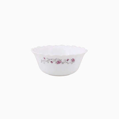 A set of white opal dinnerware with a floral pattern around the rim, including plates and bowls.