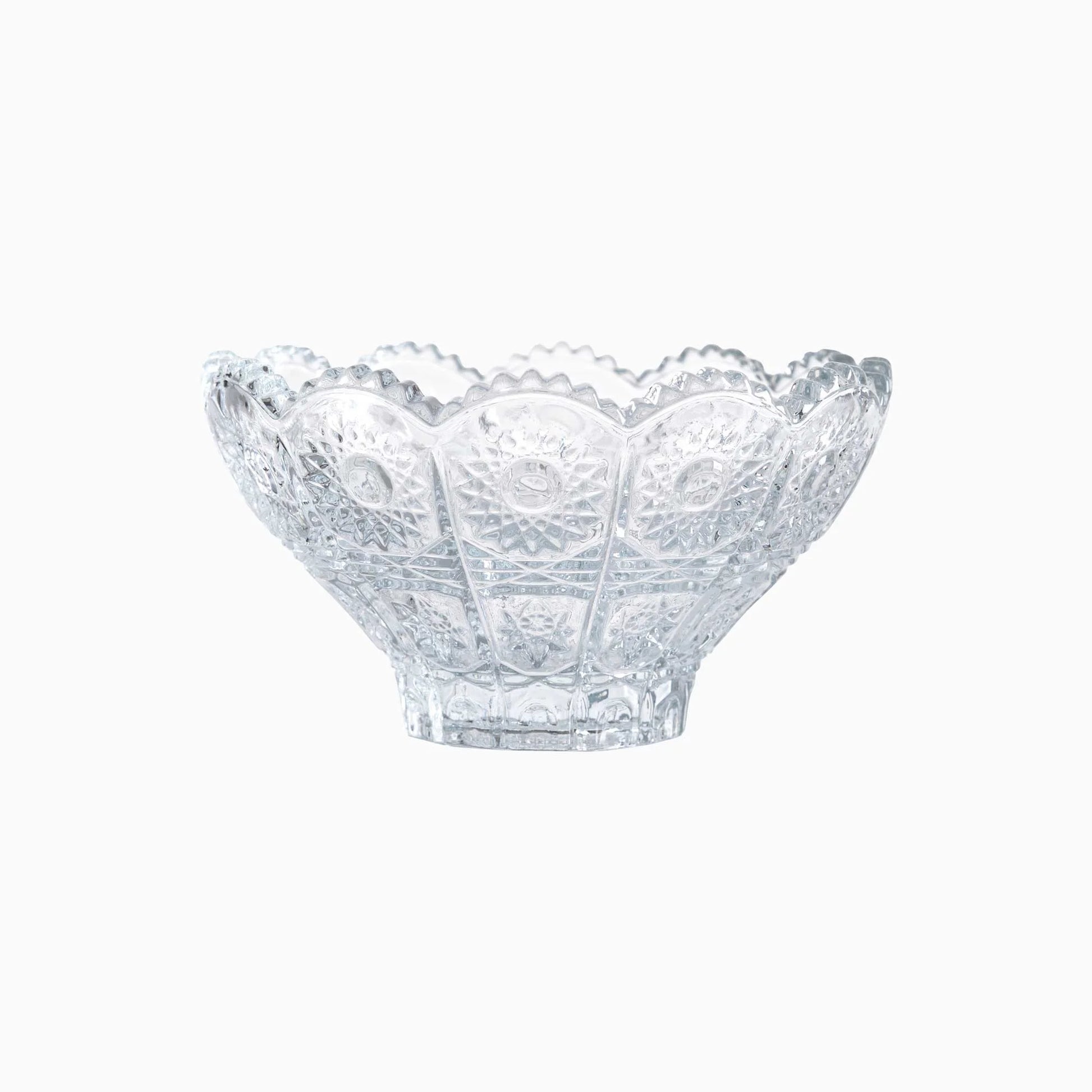 Clear glass bowl with decorative pattern on a white background