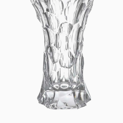 Clear glass vase with textured design on a white background