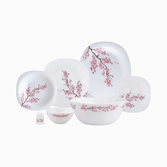 Set of white plates with pink floral patterns on a white background