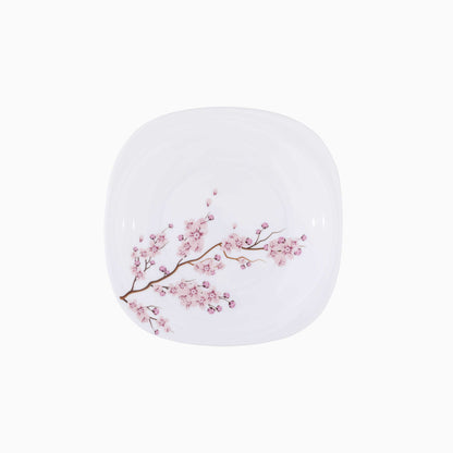 White dessert plate with pink floral design on a white background