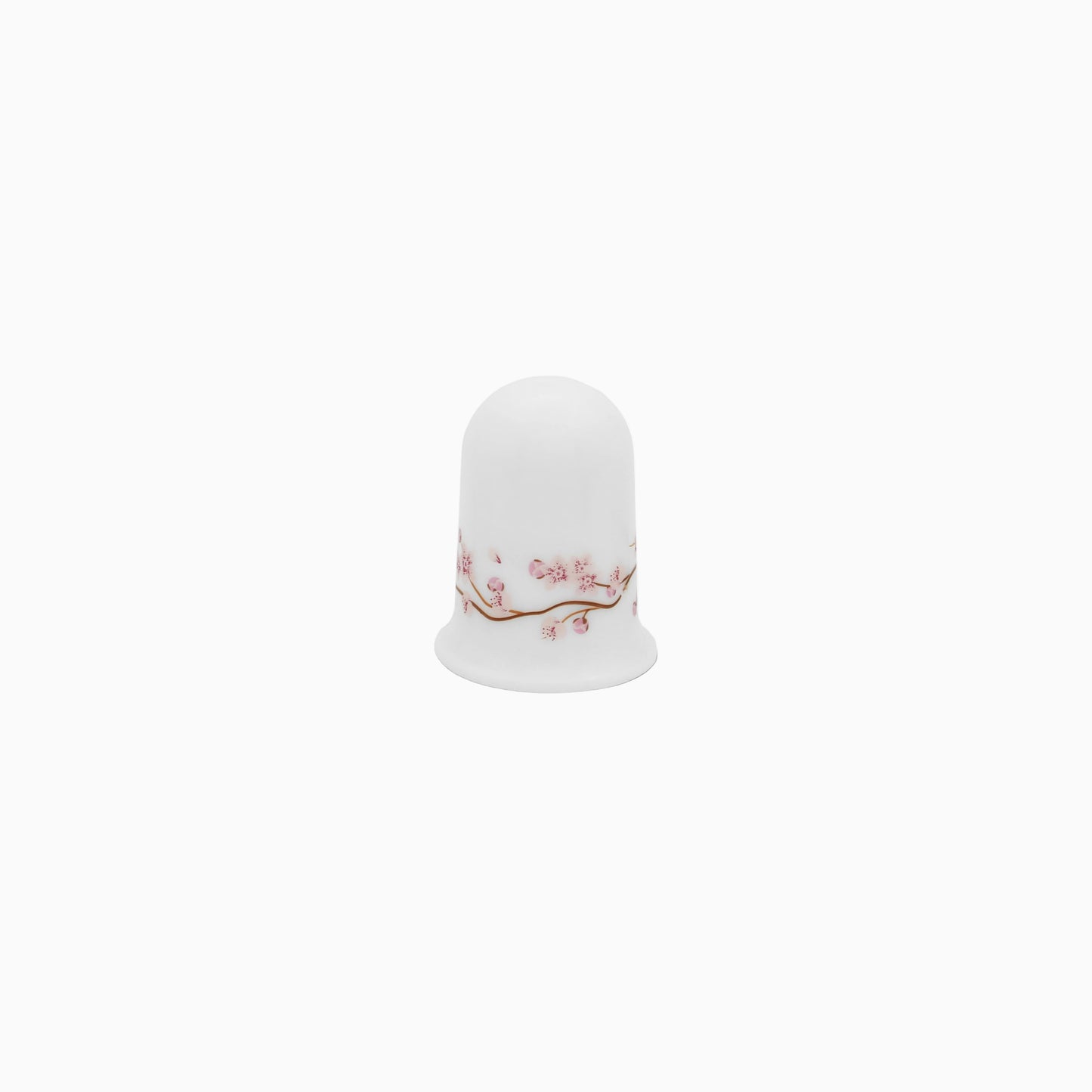 A set of white dinnerware with a pink floral pattern, including plates, bowls, and mugs.