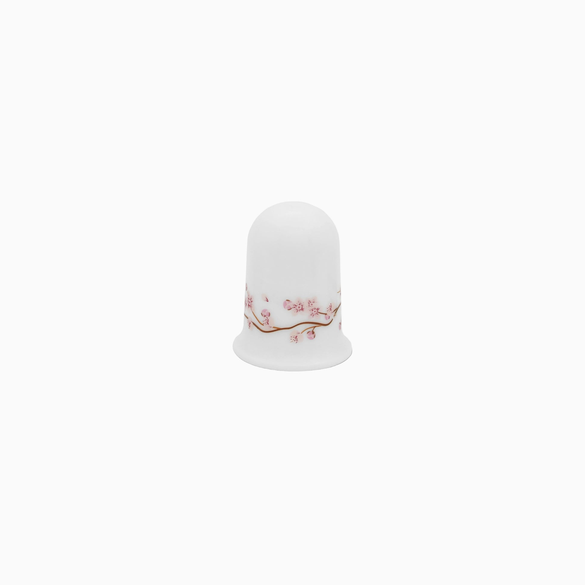 A set of white dinnerware with a pink floral pattern, including plates, bowls, and mugs.