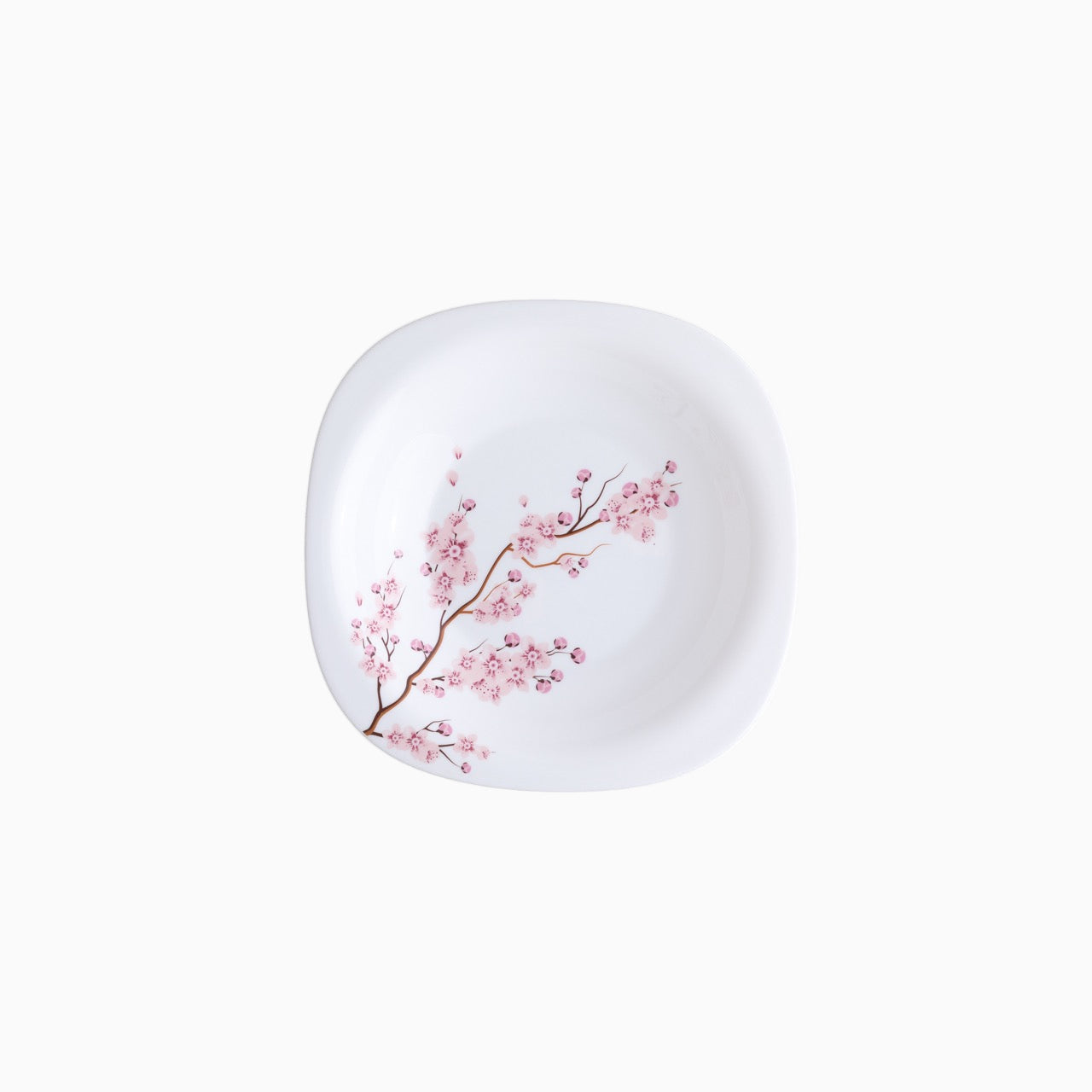 A set of white dinnerware with a pink floral pattern, including plates, bowls, and mugs.