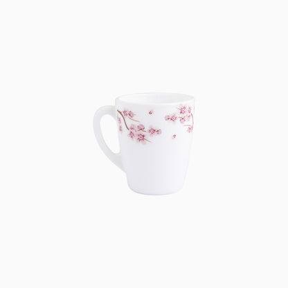 A set of white dinnerware with a pink floral pattern, including plates, bowls, and mugs.