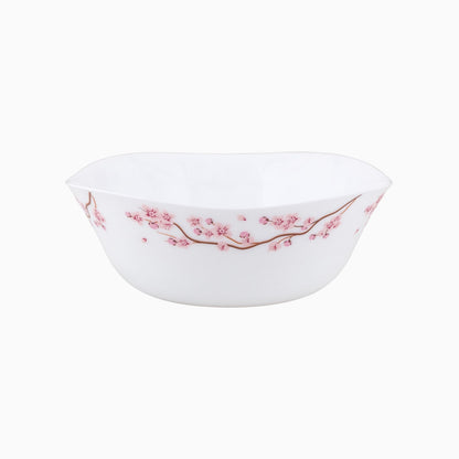 A set of white dinnerware with a pink floral pattern, including plates, bowls, and cups.