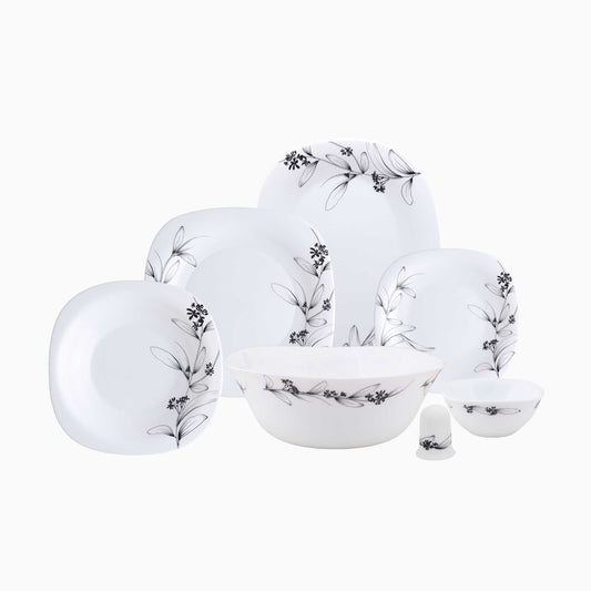 Set of white ceramic dinnerware with black floral patterns on a white background