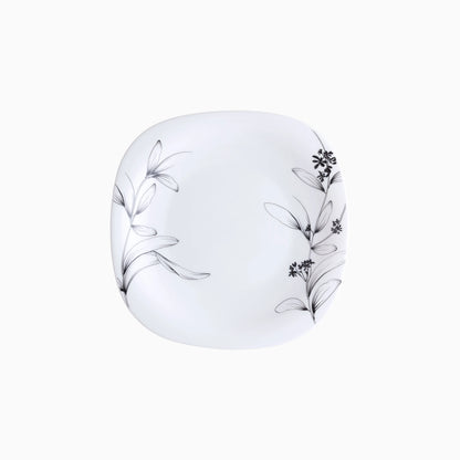 White plate with black floral patterns on a white background