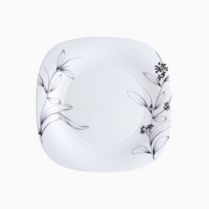 White plate with black floral patterns on a white background